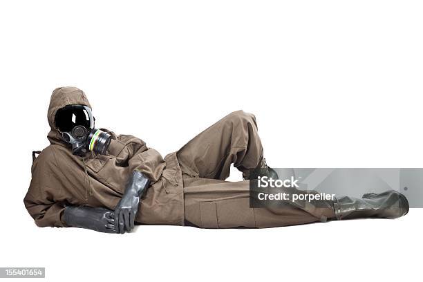 Man In Hazard Suit Layng On The Ground Stock Photo - Download Image Now - Radiation Protection Suit, Clean Suit, Men