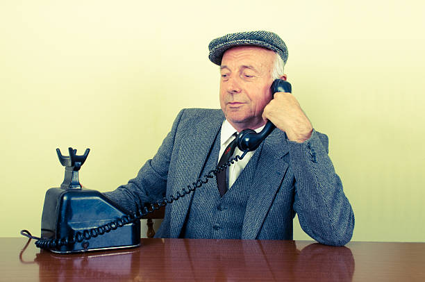 istock senior businessman with old telephone. 155402038