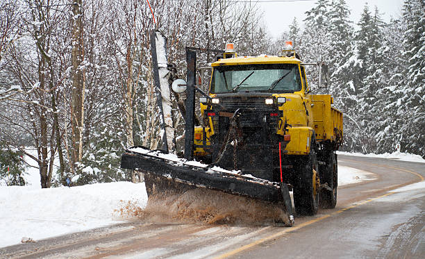 istock Snowplow plowing secondary road during snow storm 155402639