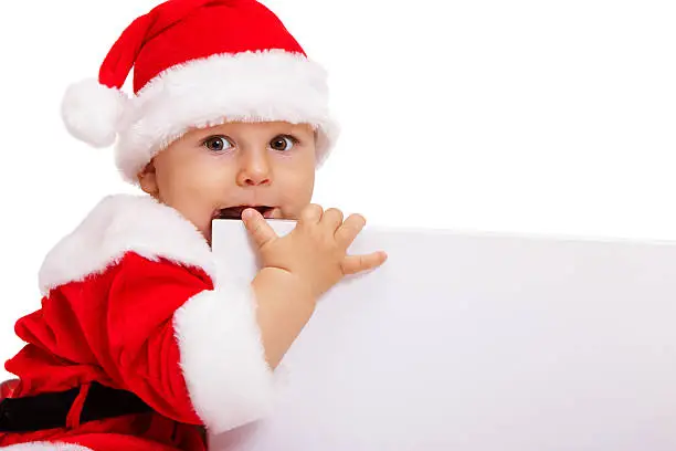 Small Santa with the poster in hands sits
