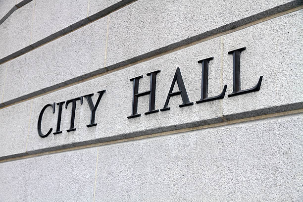 Close-up shot of a city hall sign on gray concrete wall stock photo