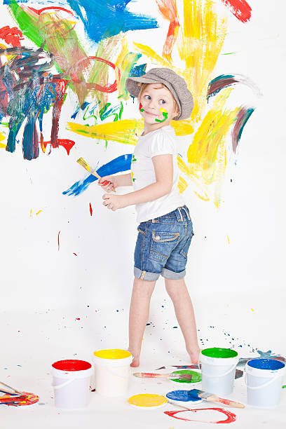 istock girl in a cap with paints 155406021