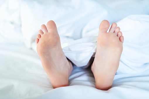 Closeup of child foot in bed