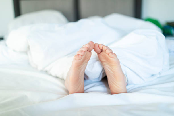 Closeup of child foot in bed