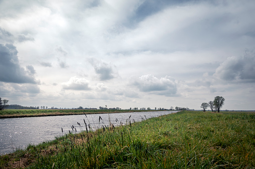 The Ems-Jade-Kanal under a blue sky with clouds. Near Dykhausen, Friesland, Lower Saxony, Germany