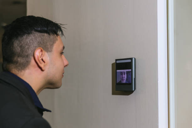 istock Man using face scanner to unlock door in office building. Access control facial recognition system. Biometric admittance control device for security system. Biometric admittance control device 1554094680