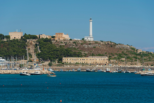 Santa Maria di Leuca, Lecce, Puglia, Italy - July 10, 2022: place where the Adriatic and Ionian seas meet. The lighthouse from the sea.