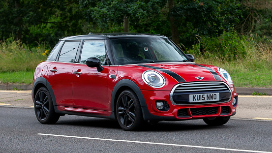 Milton Keynes,UK - July 19th 2023: 2015 red Mini Cooper car travelling on an English road