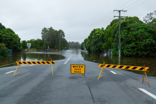 Flooded road with road block in Australia