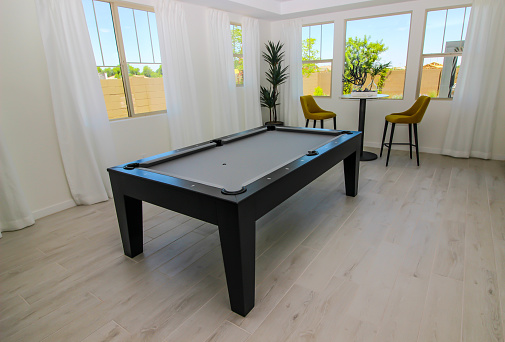 Game Room With Pool Table And Two Stool Chairs
