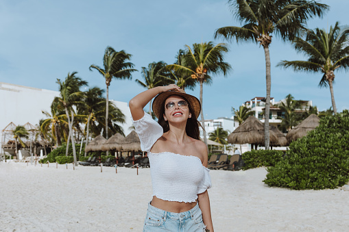 Latin woman having fun on caribbean beach in holidays or vacations in Mexico Latin America, hispanic female on tropical background
