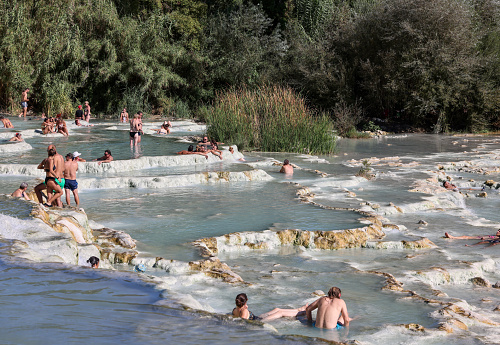 Saturnia, Italy - September 13, 2022:  People are bathing in the hot springs of Saturnia Therme, Saturnia, Tuscany, Italy