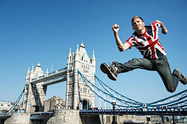 young british mann springt über die tower bridge, london - hurdle people england tower bridge stock-fotos und bilder