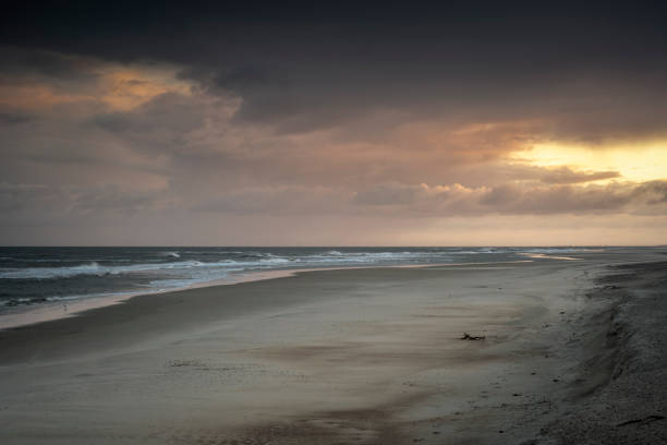 Rain clouds in the morning light over the beach in Norderney, East Frisian Islands, Lower Saxony, Germany