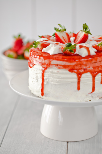 Strawberry cake, strawberry sponge cake with fresh strawberries and sour cream on a white background