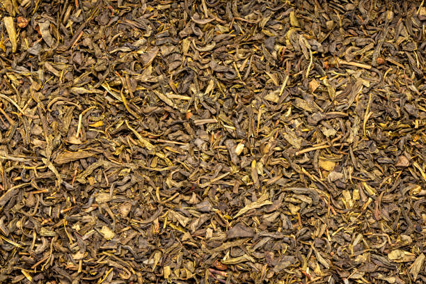 Macro blank photography of green tea, mango flavour, dry loose leaf, herbal, raw, uncooked, antioxidant, organic, natural, traditional, healthy, chinese, drink, herb