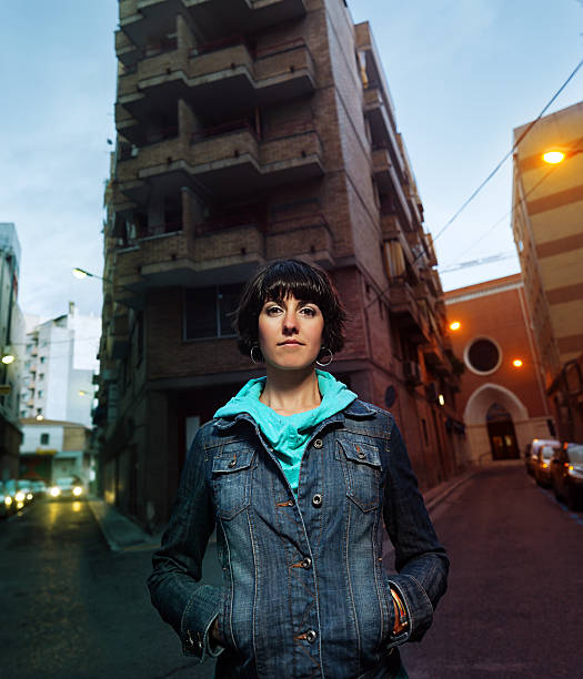 Portrait of a modern young woman in an urban scene looking at camera.