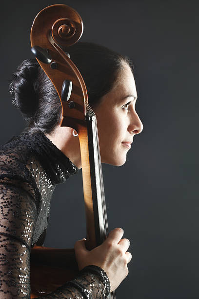 cello klassische cellist profil. - musical instrument people music young adult stock-fotos und bilder