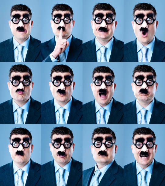 istock 12 funny facials expressions from businessman 155415733