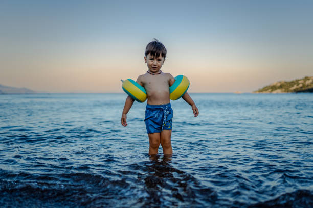 Happy  toddler boy having fun at sea