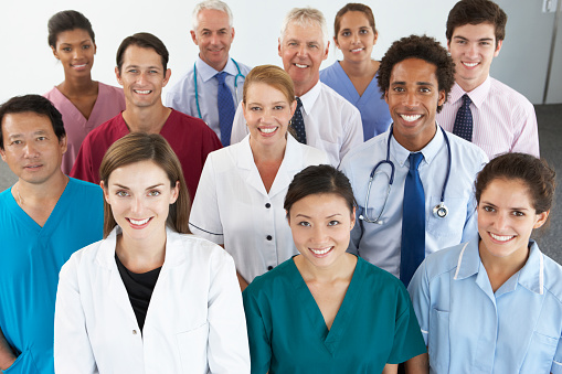 Portrait Of Group Of Workers In Medical Professions Smiling To Camera.