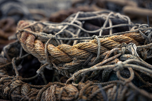 Close-up of a fishing net and a rope. Taken at the pier in Accumersiel, East Frisia, Lower Saxony, Germany