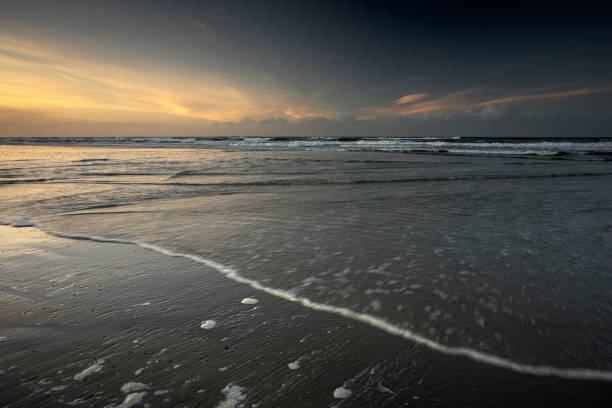 Rain clouds in the morning light over the beach in Norderney, East Frisian Islands, Lower Saxony, Germany