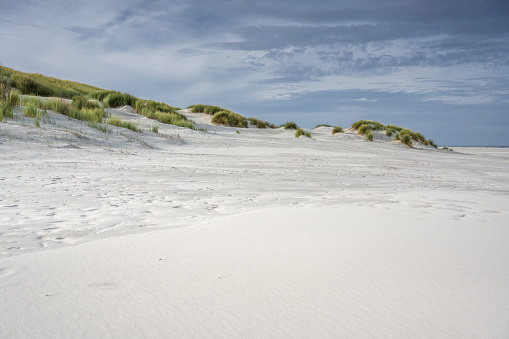 Sand dunes under blue sky at the beach