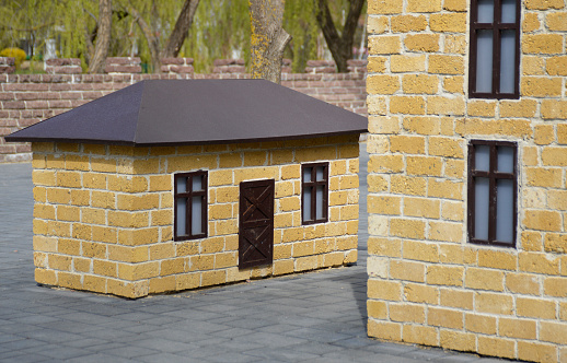 model of a one-story open-air house in the park. reconstruction of the city block. the concept of insurance, buying, selling and renting real estate