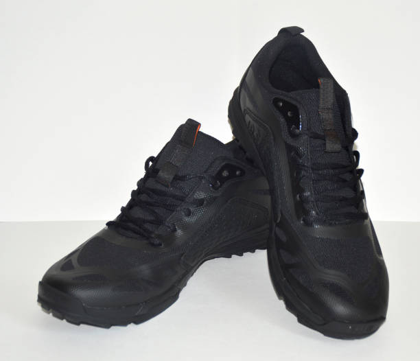 istock black sneakers on a white background. Sport shoes 1554172292