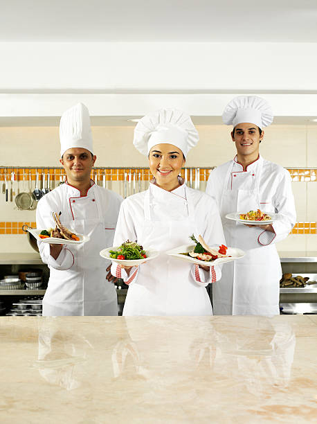 istock Chef trio serving food 155417385