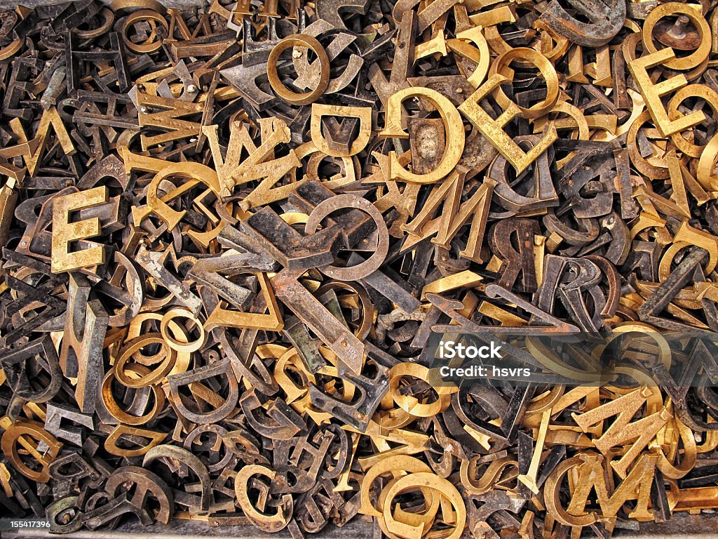 iron Letters Box full of different alphabetic iron letters. Once used to name and dates on gravestones. Letters are made in casting manufacturing process. Different font arts. Fullframe. HDR. Alphabet Stock Photo