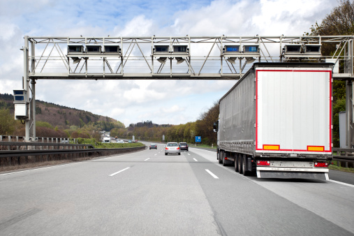 Trucks and cars on german highway, toll system gantry