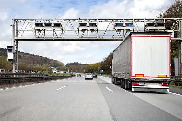 Photo of Trucks and cars on german highway, toll system gantry