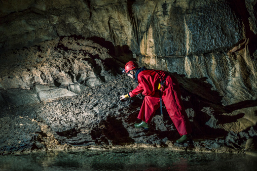Geologist exploring caves deep underground.