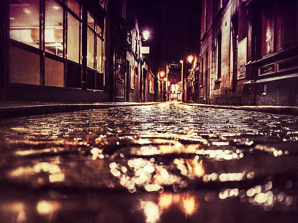 A dark backstreet in downtown Dublin during a rainy night.