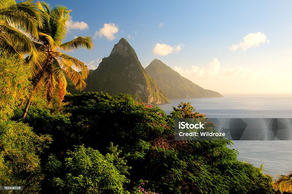 St. Lucia's Twin Pitons lit by sunset glow  Saint Lucia Stock Photo