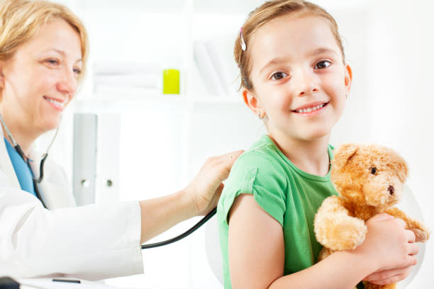 istock Child with teddy bear at doctors office. 155418848