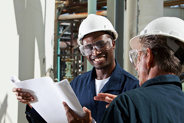 istock Multiracial industrial workers reviewing plans 155418950