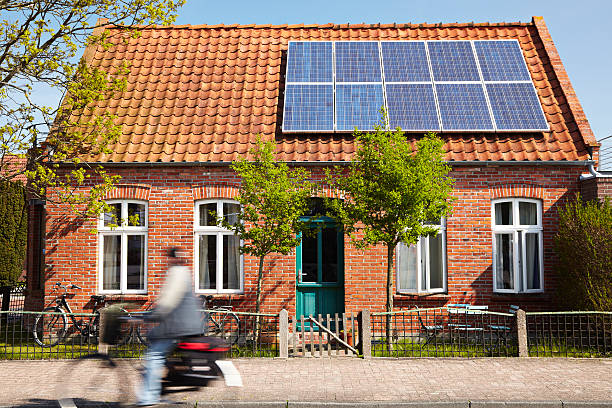Cute house Little Traditional northern Brick house with photovoltaic technology on the roof netherlands stock pictures, royalty-free photos & images