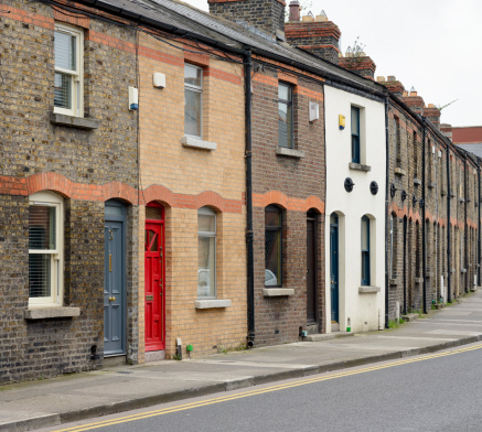 View along a street of traditional terraced brick houses in Dublin, Ireland.