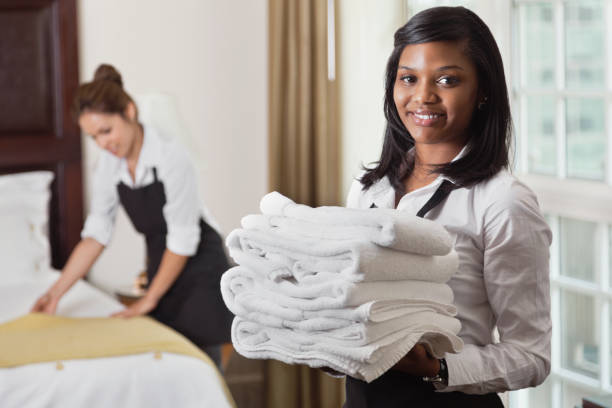istock Young maid with towels in hotel room 155419929