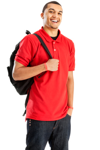 Photo of a young African Amercan male student in red, carrying a book bag over one shoulder; isolated on white.