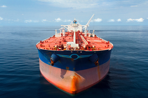 Aerial photo of a large oil tanker floating in calm seas.