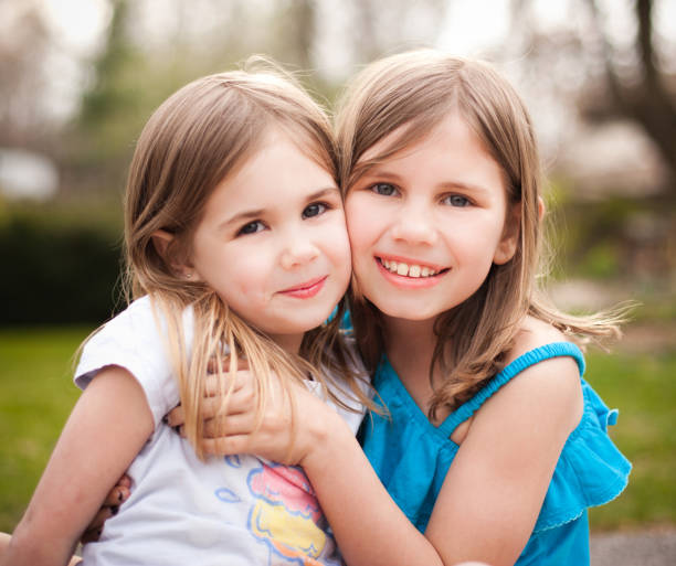 istock Two Young Sisters Smiling at the Camera 155420276