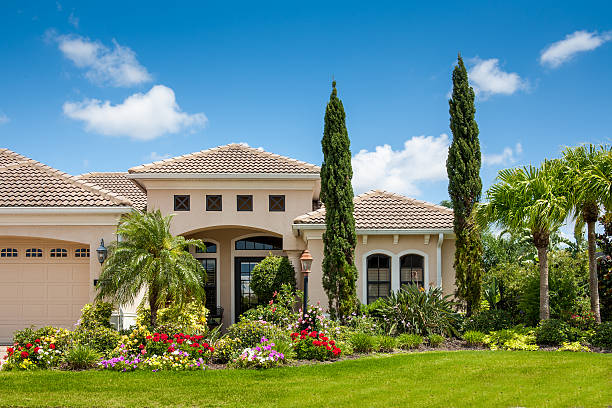 Upscale Home with Gorgeous Flower Garden  ornamental garden palm tree bush flower stock pictures, royalty-free photos & images