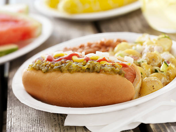 BBQ Hotdog with Lemonade BBQ Hotdog with Mustard, Ketchup, Relish and Onions with Potato Salad and Baked Beans at a Picnic -Photographed on Hasselblad H3D2-39mb Camera relish stock pictures, royalty-free photos & images