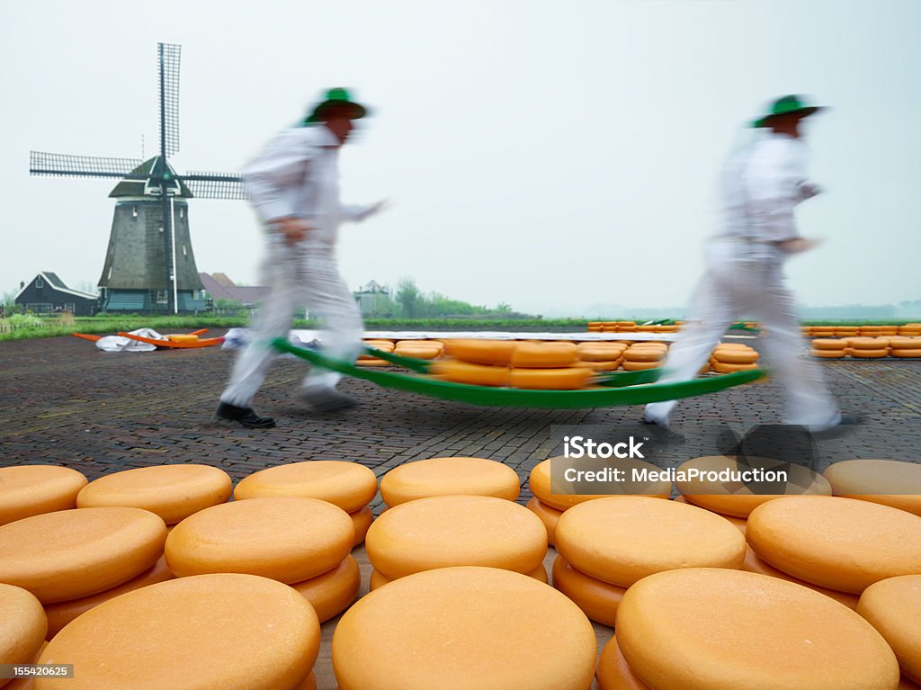 Dutch Cheese Market Dutch cheese market,, workers carrying a pile of cheese on a specially designed trolley hanging from their shoulders. Netherlands Stock Photo