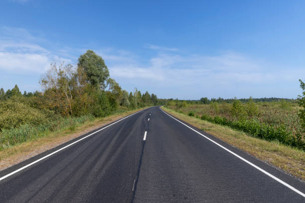 istock Narrow paved road for cars 1554210028