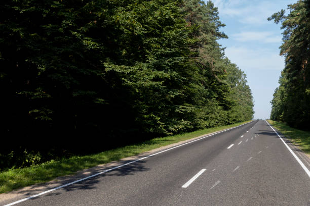 istock Narrow paved road for cars 1554210071